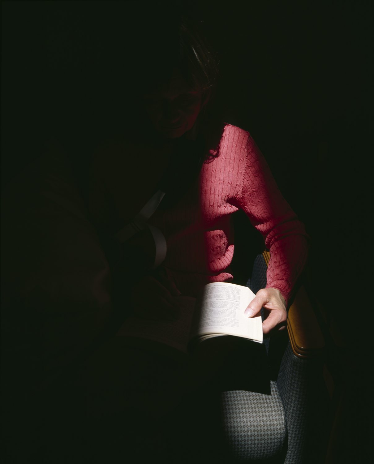 Women Reading in a Sunlight Spotlight with a Sling