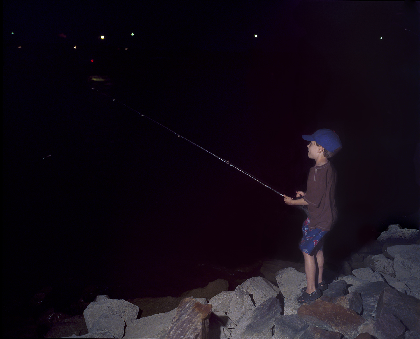 Boy Fishing at Night